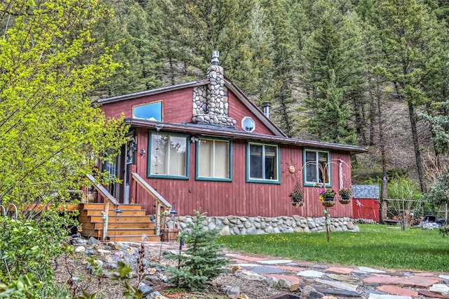 8229 York Rd, Helena, MT 59602 - view of front facade with a wooded view and a chimney
