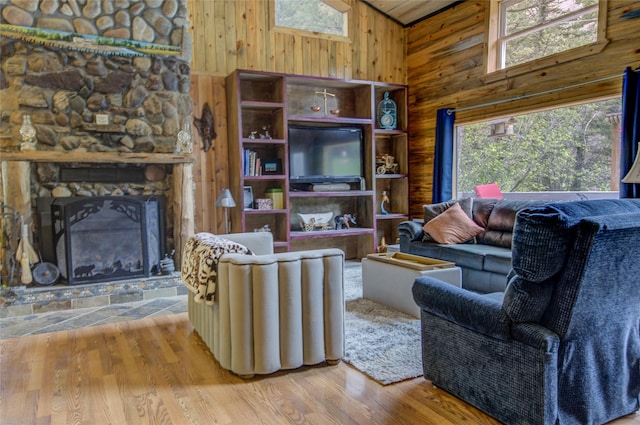 8229 York Rd, Helena, MT 59602 - living room with wood walls, plenty of natural light, wood finished floors, a fireplace, and high vaulted ceiling