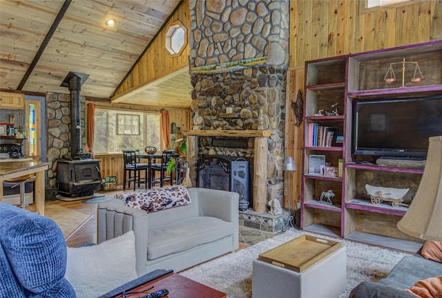 8229 York Rd, Helena, MT 59602 - living area featuring wood walls, a wood stove, plenty of natural light, wooden ceiling, and high vaulted ceiling