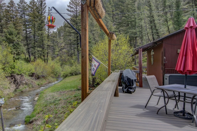 8229 York Rd, Helena, MT 59602 - deck featuring a forest view, outdoor dining space, and area for grilling