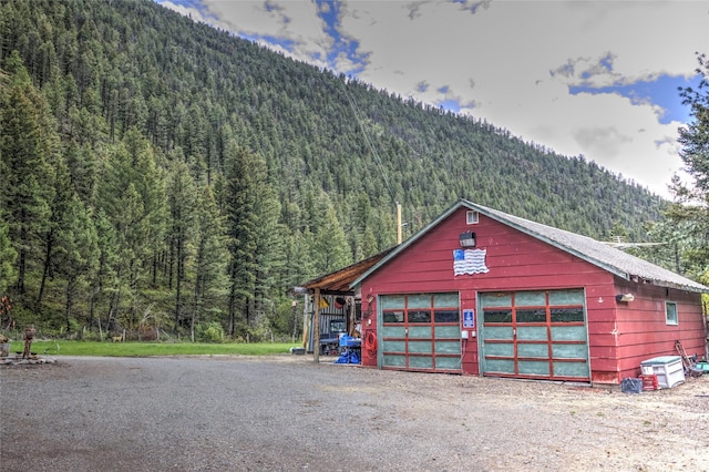 8229 York Rd, Helena, MT 59602 - detached garage featuring a wooded view and a mountain view