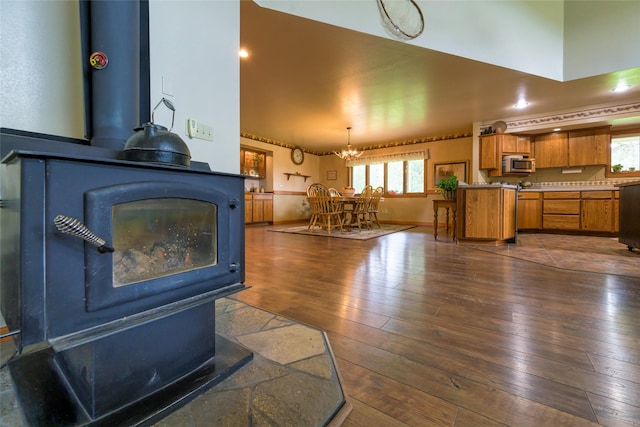 5380 US Highway 93, Conner, MT 59827 - living area featuring a wood stove, dark wood finished floors, a towering ceiling, and a chandelier