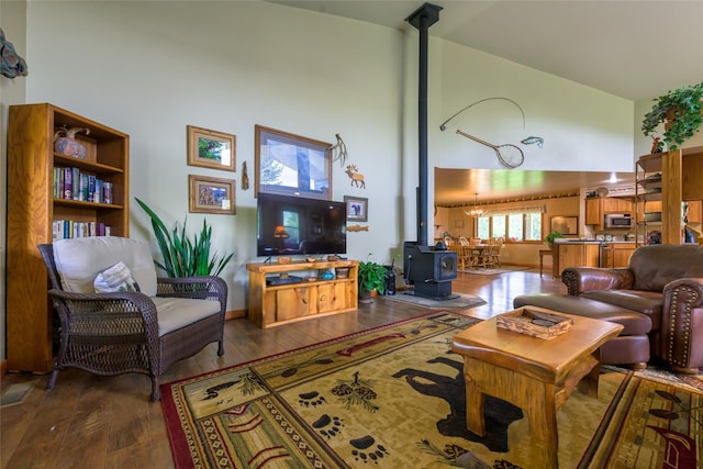 5380 US Highway 93, Conner, MT 59827 - living area with a towering ceiling, a wood stove, and hardwood / wood-style floors
