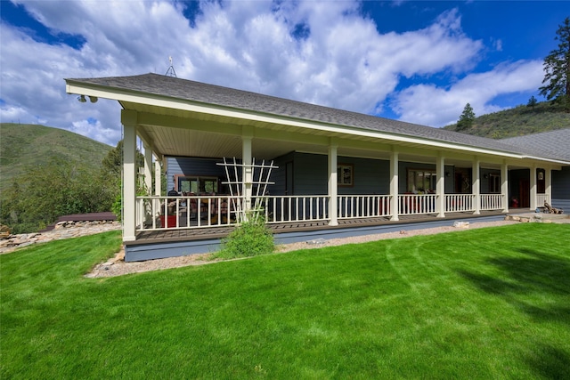 5380 US Highway 93, Conner, MT 59827 - back of house with a porch, a yard, a mountain view, and roof with shingles