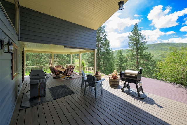 5380 US Highway 93, Conner, MT 59827 - wooden deck featuring a grill, outdoor dining space, and a mountain view