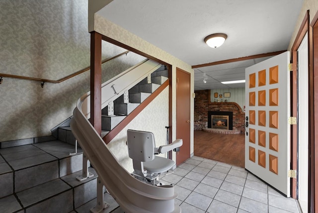 30 Panoramic Dr, Kalispell, MT 59901 - stairs with wallpapered walls, tile patterned flooring, and a fireplace