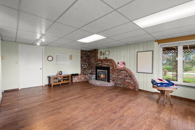30 Panoramic Dr, Kalispell, MT 59901 - living room featuring a paneled ceiling, wood finished floors, and a brick fireplace