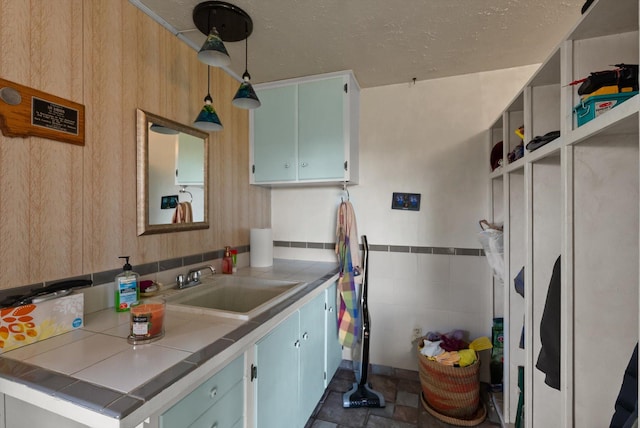 30 Panoramic Dr, Kalispell, MT 59901 - kitchen featuring tile countertops, blue cabinetry, and hanging light fixtures