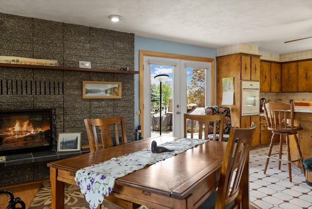 30 Panoramic Dr, Kalispell, MT 59901 - dining room featuring light floors, french doors, and a fireplace
