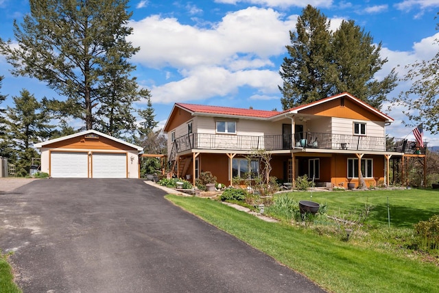 30 Panoramic Dr, Kalispell, MT 59901 - view of front of house featuring an outbuilding, a front lawn, a detached garage, and a deck