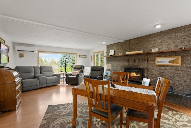 30 Panoramic Dr, Kalispell, MT 59901 - dining area featuring a wall unit AC, a brick fireplace, wood finished floors, and recessed lighting