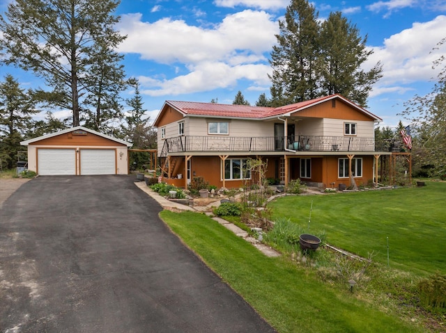 30 Panoramic Dr, Kalispell, MT 59901 - view of front of home with an outdoor structure, a garage, a front yard, a deck, and a metal roof
