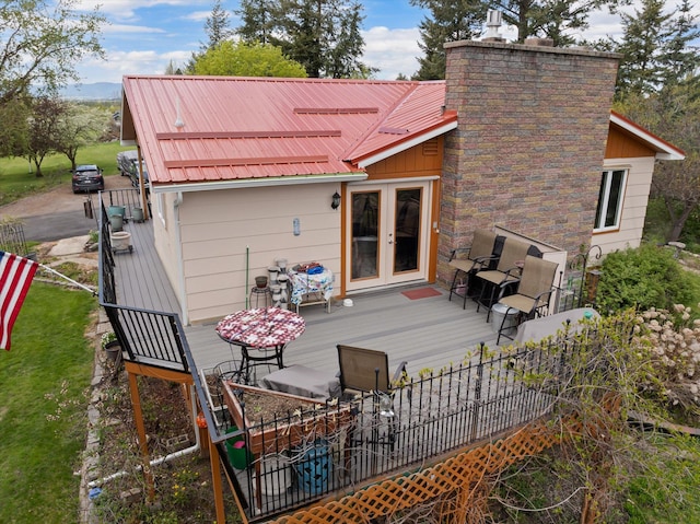 30 Panoramic Dr, Kalispell, MT 59901 - back of property with french doors, a wooden deck, and a metal roof
