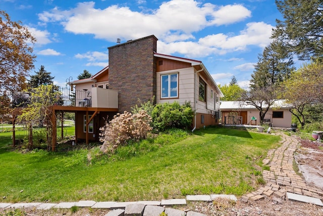 30 Panoramic Dr, Kalispell, MT 59901 - view of home's exterior featuring a wooden deck, a lawn, stairway, and a chimney