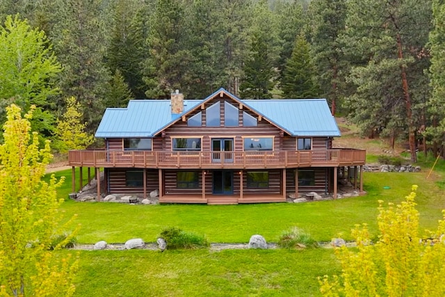 629 Alvista Loop, Hamilton, MT 59840 - rear view of property with a chimney, a deck, a forest view, and a lawn