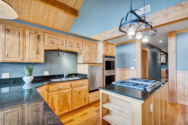629 Alvista Loop, Hamilton, MT 59840 - kitchen with a sink, light wood-style floors, a wainscoted wall, appliances with stainless steel finishes, and dark stone counters
