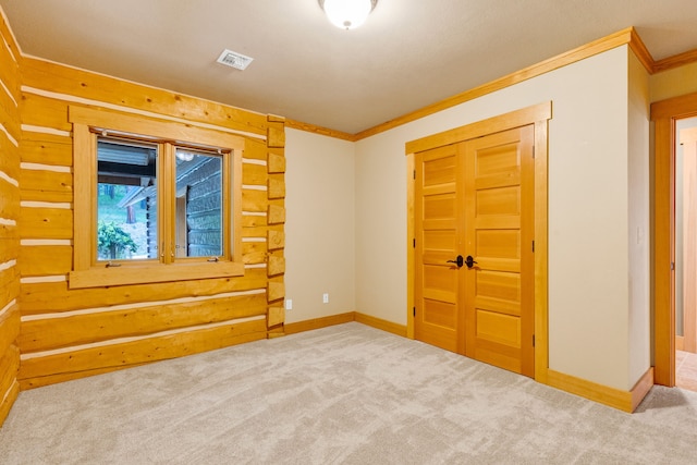 629 Alvista Loop, Hamilton, MT 59840 - carpeted empty room featuring crown molding, baseboards, and log walls