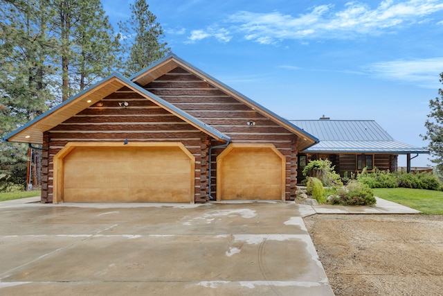 629 Alvista Loop, Hamilton, MT 59840 - log home with an attached garage, metal roof, log siding, and driveway