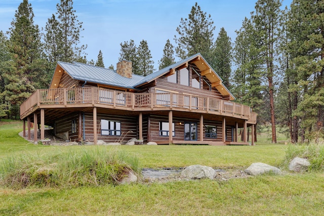 629 Alvista Loop, Hamilton, MT 59840 - back of property featuring a chimney, a wooden deck, a lawn, metal roof, and a standing seam roof
