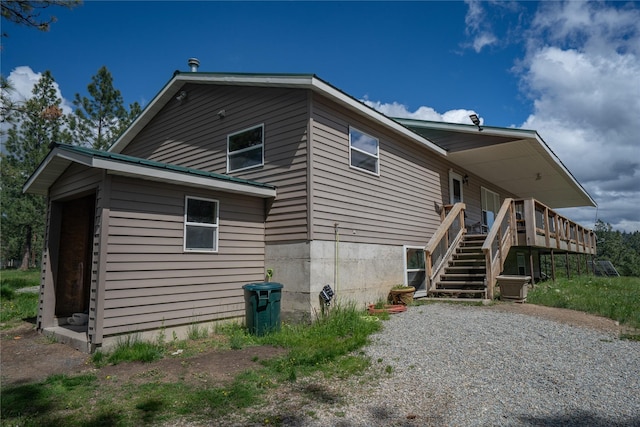3185 Hubbart Dam Rd, Marion, MT 59925 - rear view of house featuring stairway and a deck