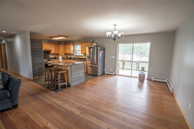 3185 Hubbart Dam Rd, Marion, MT 59925 - kitchen with stainless steel appliances, a baseboard radiator, a sink, and hardwood / wood-style flooring
