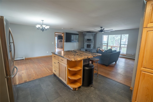 3185 Hubbart Dam Rd, Marion, MT 59925 - kitchen featuring freestanding refrigerator, a baseboard heating unit, ceiling fan, a chandelier, and a baseboard radiator