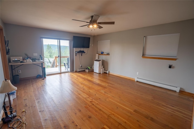 3185 Hubbart Dam Rd, Marion, MT 59925 - living room with a baseboard heating unit, ceiling fan, light wood-style flooring, and baseboards