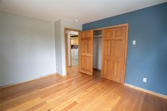 3185 Hubbart Dam Rd, Marion, MT 59925 - unfurnished bedroom featuring baseboards, light wood finished floors, a closet, and washer and clothes dryer
