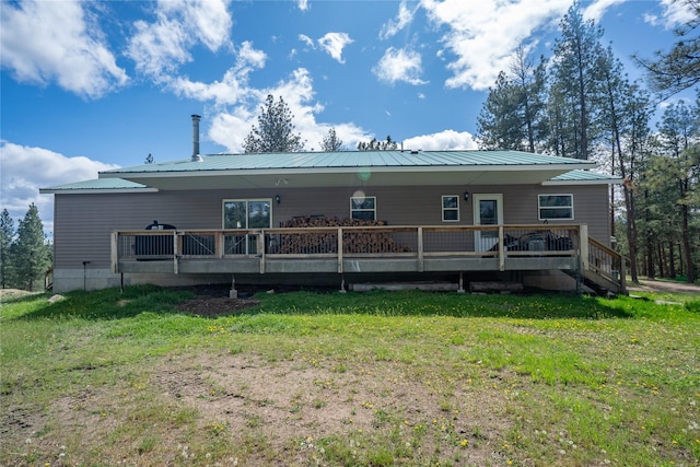 3185 Hubbart Dam Rd, Marion, MT 59925 - rear view of property with metal roof, a yard, and a wooden deck