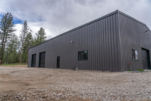 3185 Hubbart Dam Rd, Marion, MT 59925 - view of side of property with a pole building, a detached garage, and an outbuilding
