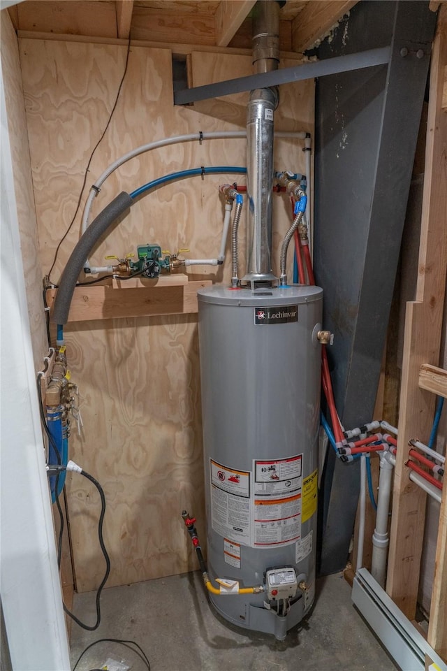 3185 Hubbart Dam Rd, Marion, MT 59925 - utility room with gas water heater and a baseboard heating unit