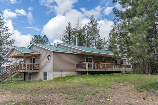 3185 Hubbart Dam Rd, Marion, MT 59925 - back of house featuring a wooden deck, metal roof, and stairway
