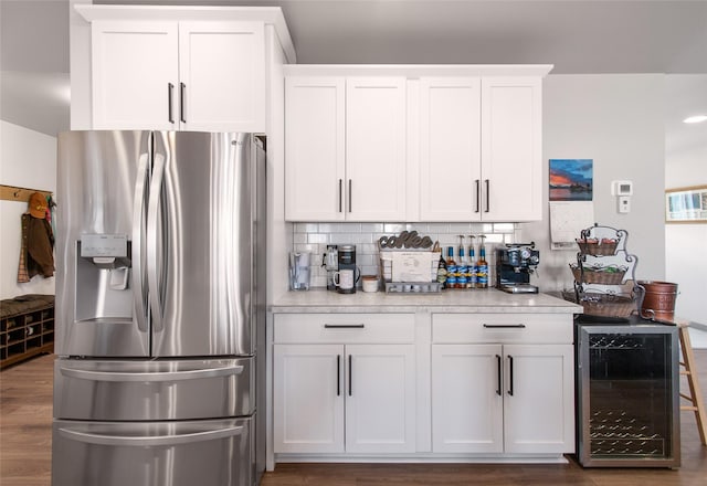 3870 Swan Rd, East Helena, MT 59635 - kitchen with stainless steel refrigerator with ice dispenser, wine cooler, white cabinetry, light countertops, and wood finished floors