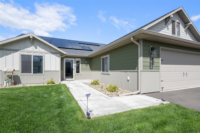 3870 Swan Rd, East Helena, MT 59635 - ranch-style home featuring solar panels, a front lawn, and a garage