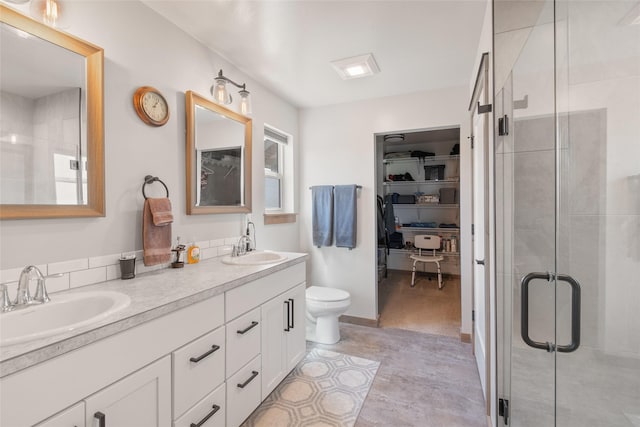 3870 Swan Rd, East Helena, MT 59635 - full bath with double vanity, a stall shower, a walk in closet, and toilet