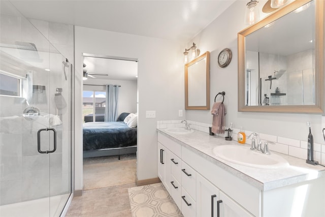 3870 Swan Rd, East Helena, MT 59635 - bathroom with double vanity, a shower stall, ensuite bath, a ceiling fan, and tile patterned floors