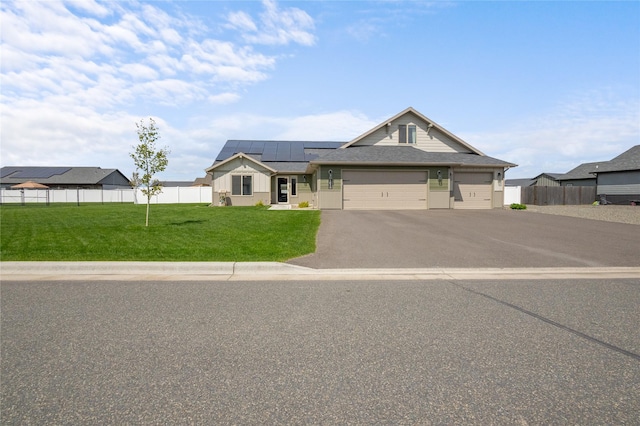 3870 Swan Rd, East Helena, MT 59635 - view of front of house with roof mounted solar panels, driveway, and an attached garage