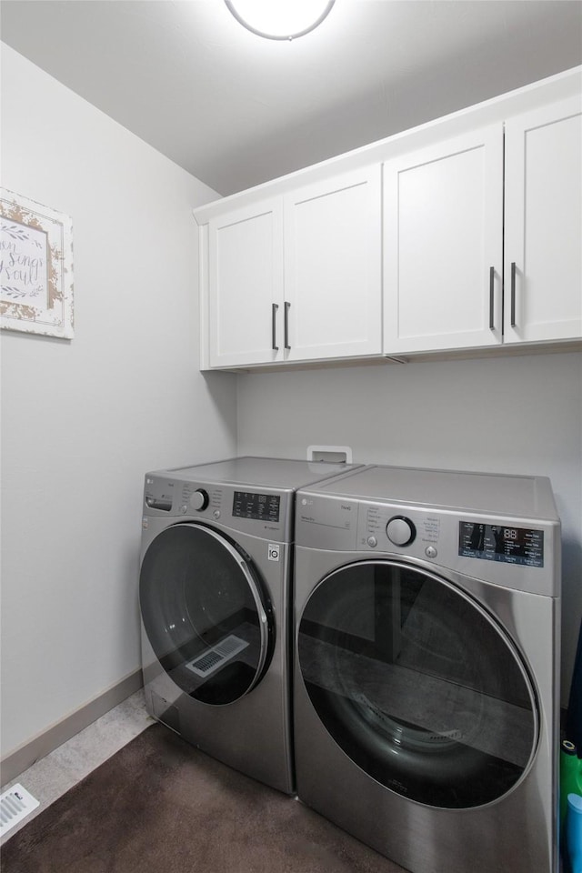 3870 Swan Rd, East Helena, MT 59635 - washroom featuring cabinet space, washer and clothes dryer, baseboards, and dark carpet