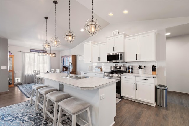 3870 Swan Rd, East Helena, MT 59635 - kitchen with appliances with stainless steel finishes, a sink, light countertops, lofted ceiling, and dark wood-style flooring