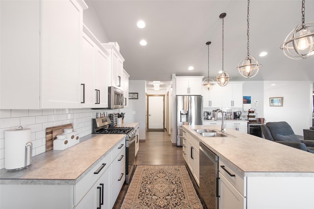 3870 Swan Rd, East Helena, MT 59635 - kitchen with stainless steel appliances, a sink, light countertops, tasteful backsplash, and a center island with sink