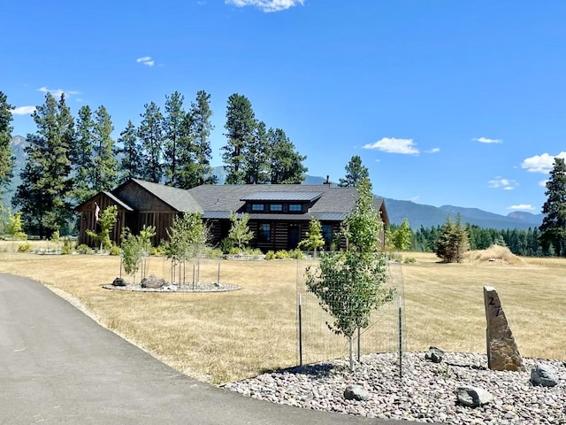 27 Elk Meadow Ln, Kalispell, MT 59901 - view of front of house with a front yard, a mountain view, and log exterior