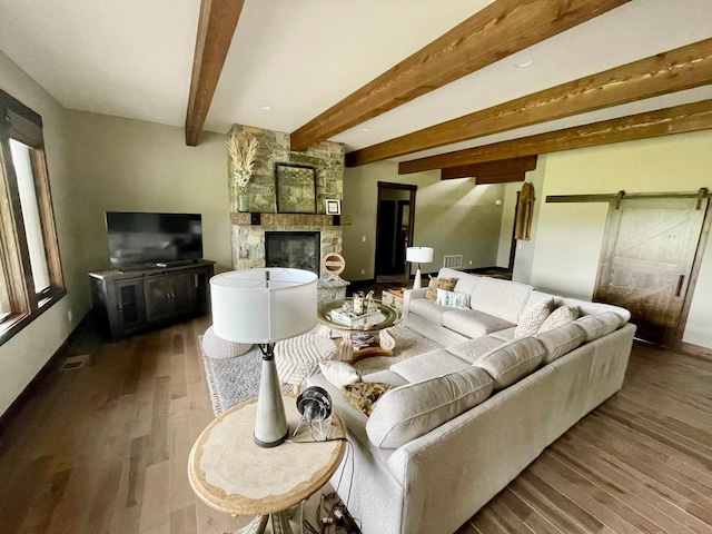 27 Elk Meadow Ln, Kalispell, MT 59901 - living area with a barn door, dark wood-style flooring, beamed ceiling, and a fireplace