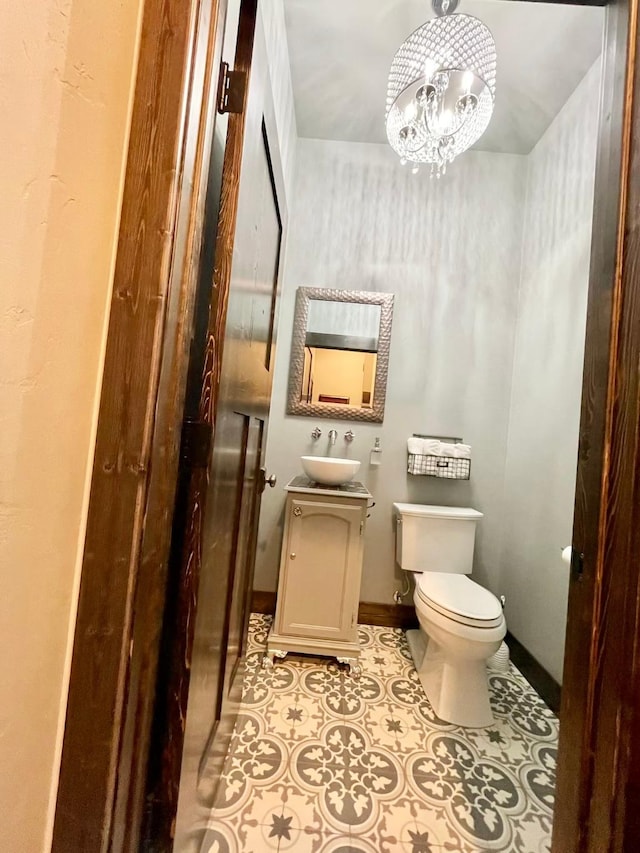 27 Elk Meadow Ln, Kalispell, MT 59901 - bathroom featuring toilet, vanity, a chandelier, and tile patterned flooring