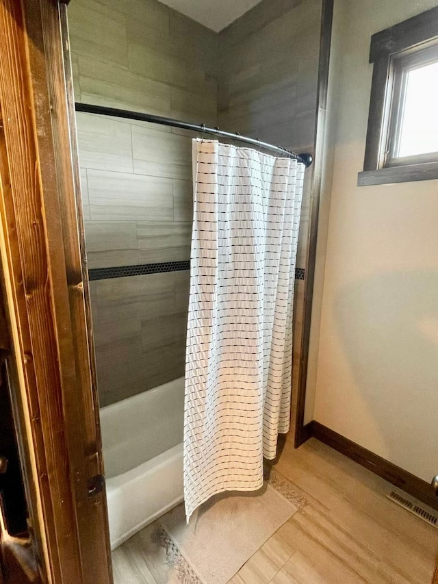 27 Elk Meadow Ln, Kalispell, MT 59901 - full bath with shower / bathtub combination with curtain, wood finished floors, and baseboards