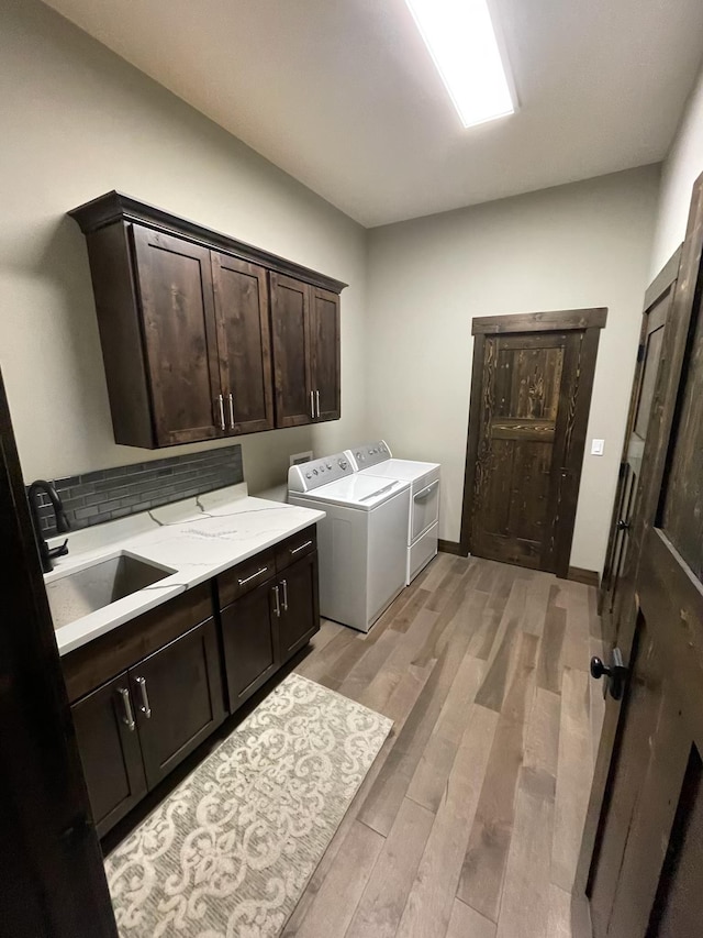 27 Elk Meadow Ln, Kalispell, MT 59901 - washroom with cabinet space, separate washer and dryer, and light wood finished floors