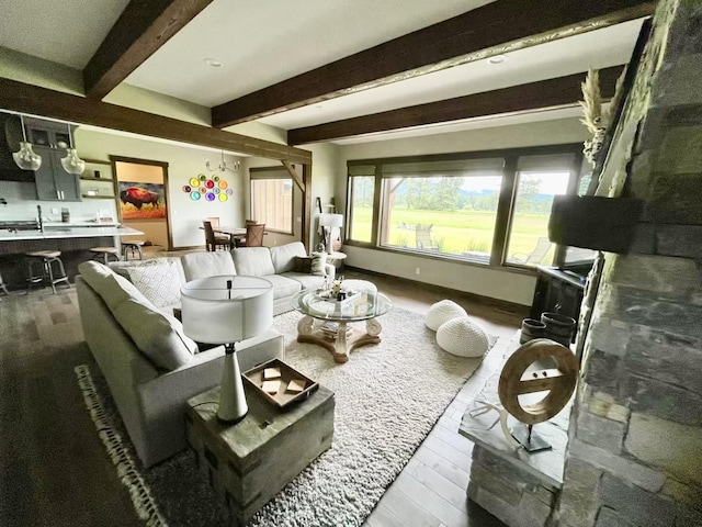 27 Elk Meadow Ln, Kalispell, MT 59901 - living area with wood finished floors, beamed ceiling, and baseboards