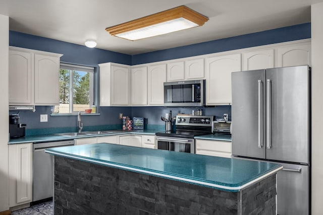 5 Darlene Rd, Columbia Falls, MT 59912 - kitchen featuring stainless steel appliances, white cabinetry, a sink, a center island, and dark countertops