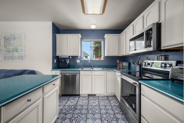 5 Darlene Rd, Columbia Falls, MT 59912 - kitchen with appliances with stainless steel finishes, a sink, white cabinets, and light tile patterned floors