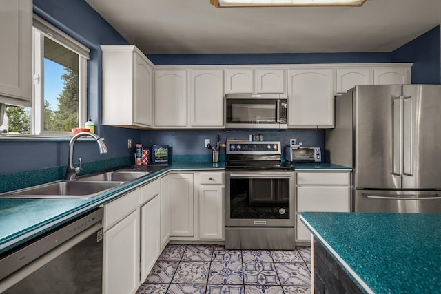 5 Darlene Rd, Columbia Falls, MT 59912 - kitchen featuring appliances with stainless steel finishes, a sink, white cabinetry, and dark countertops