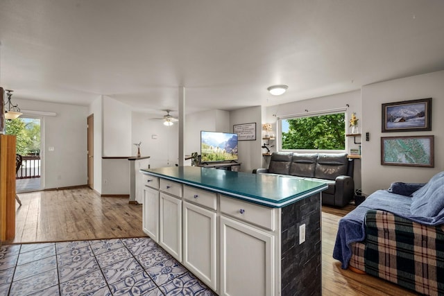 5 Darlene Rd, Columbia Falls, MT 59912 - kitchen with open floor plan, a center island, white cabinets, dark countertops, and a ceiling fan